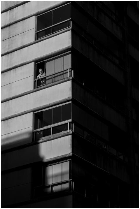 Black and white urban scene with a person in a Bue