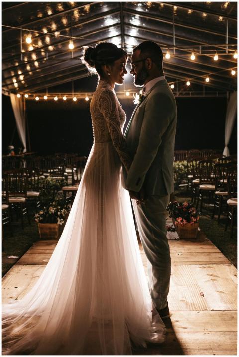 Elegant bride and groom embracing under twinkling