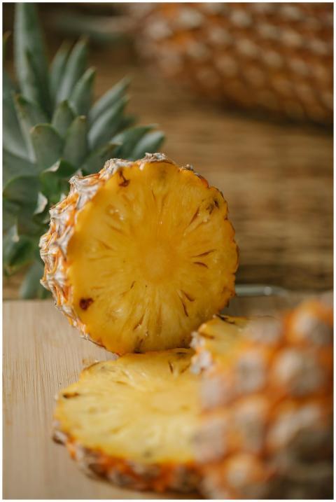 Close-up of ripe, juicy pineapple slices on a wood