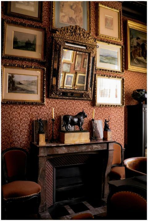 Sophisticated Parisian room with a fireplace, art,