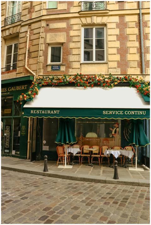 A charming Parisian cafe with colorful awning and