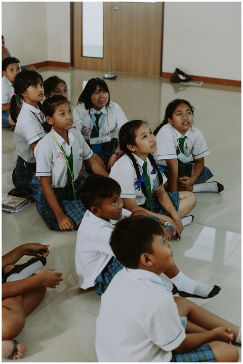 Group of school children in a classroom sitting on