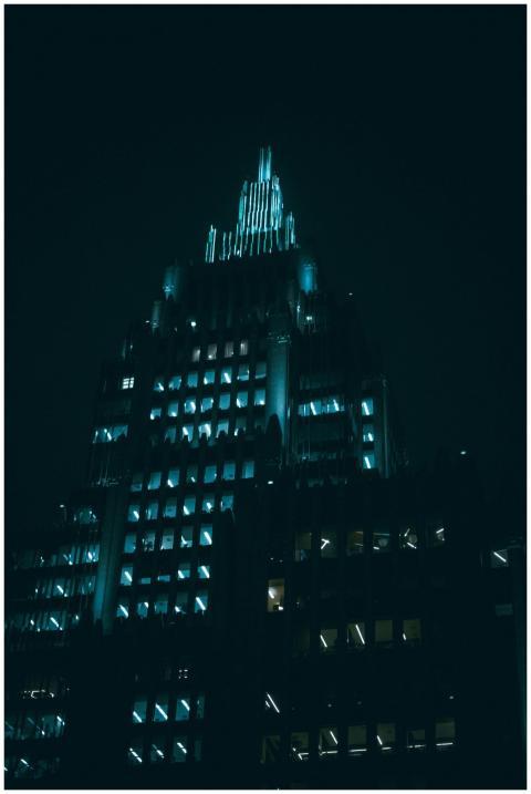 A dramatic night view of a modern skyscraper in Mo
