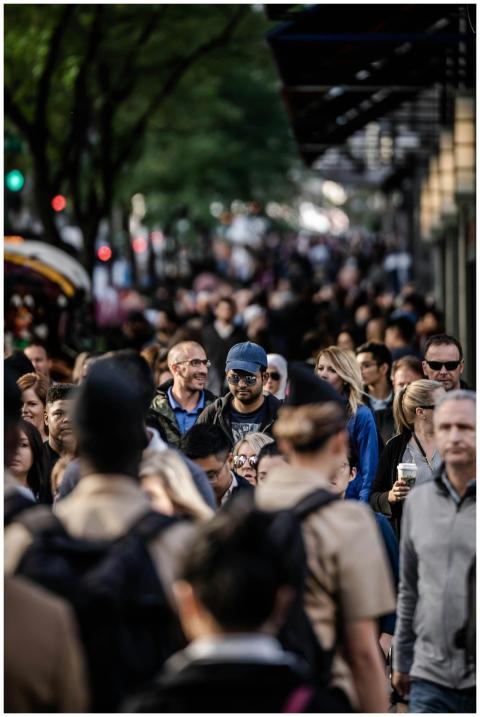 A bustling urban scene with diverse people walking
