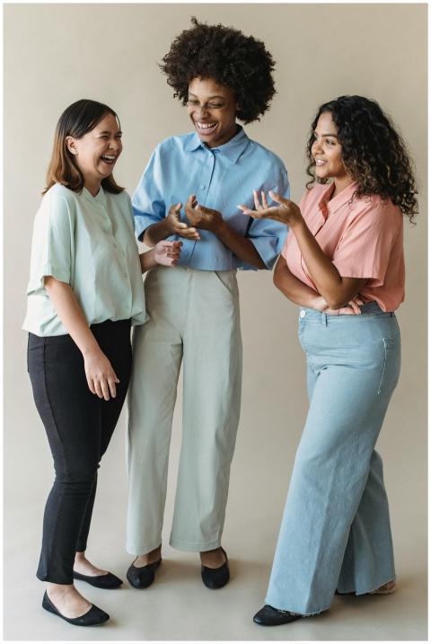 Three diverse women laughing and bonding in a joyf