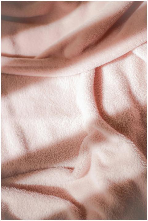 Close-up of a soft pink velvet fabric with rippled
