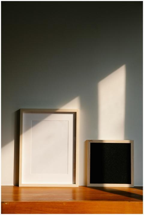Minimalist wooden frames casting shadows on a wood