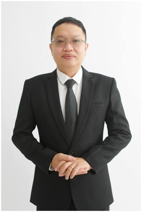 Portrait of a businessman in a black suit standing