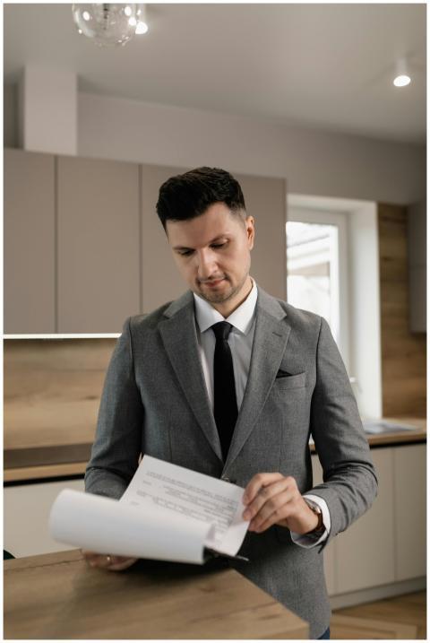Male real estate agent in suit reviewing property
