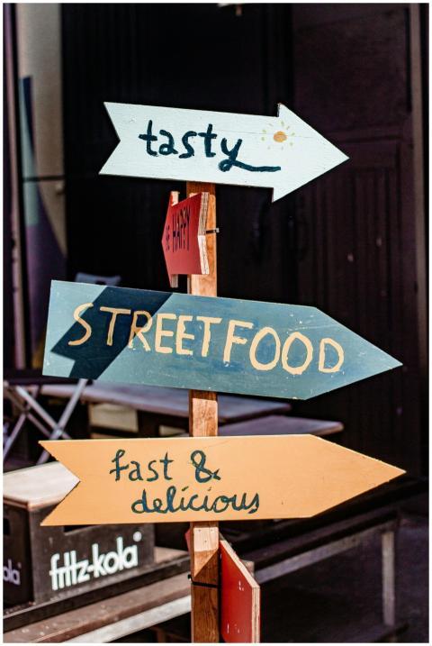 Vibrant street food sign in Riga, pointing to tast