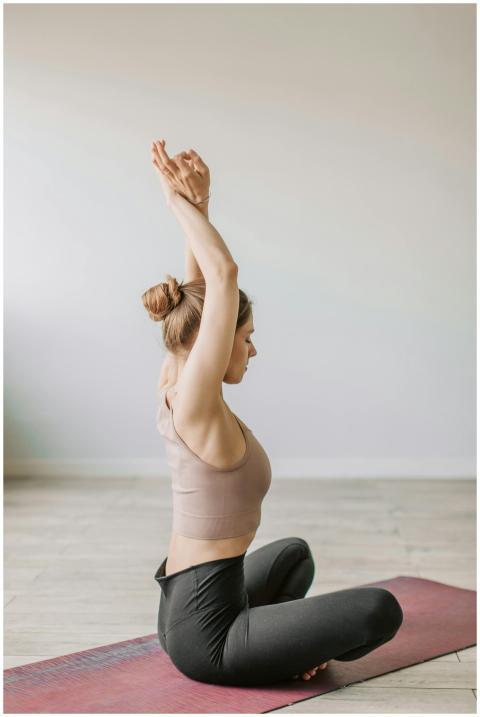 A woman in a yoga pose on a mat, emphasizing relax