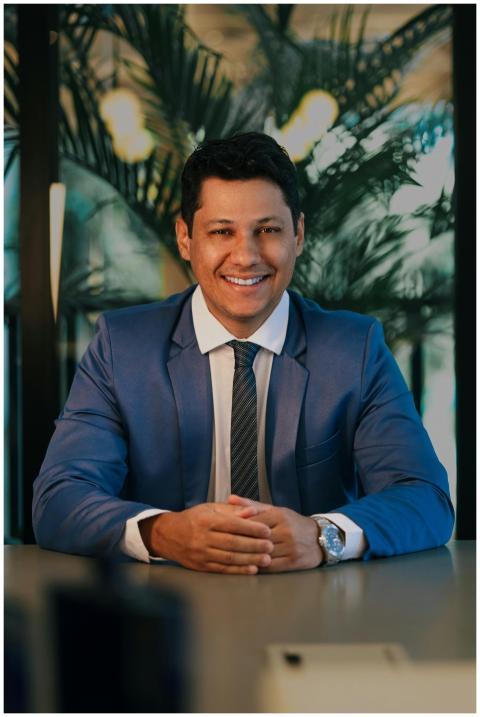 Confident businessman in a blue suit smiling at a