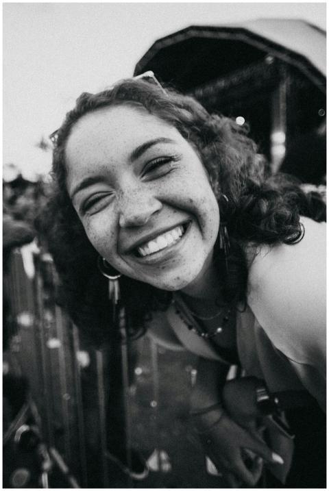Cheerful black and white portrait of a young woman