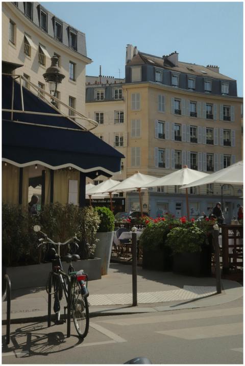 Sunny day in Paris with quaint cafes and classic a