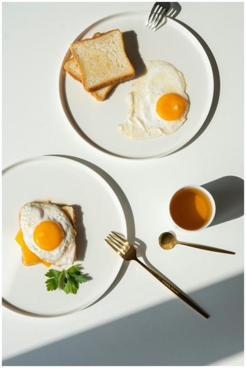 Minimalist breakfast featuring fried eggs, toast,