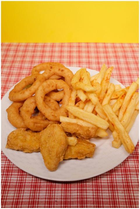 High angle of fried potato with onion rings and nu
