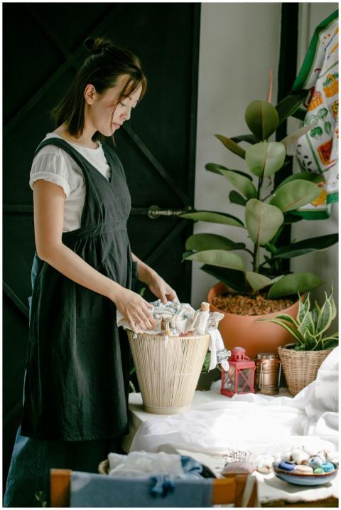 Side view of serious Asian female designer standin