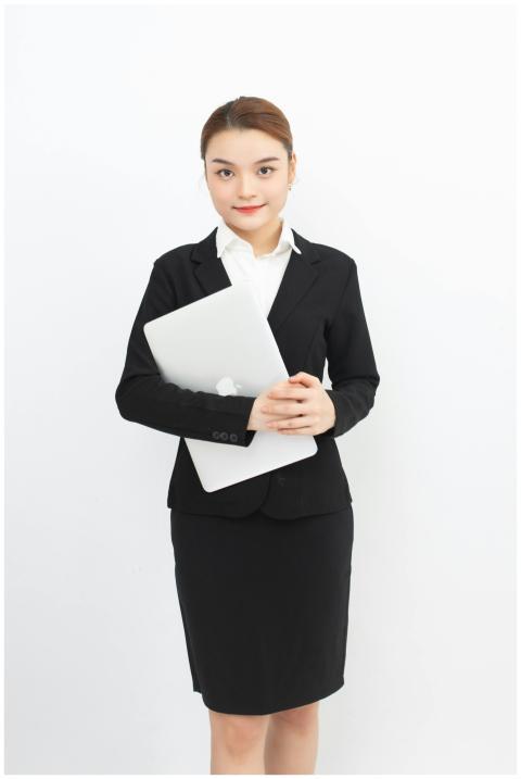 Confident woman in formal business attire holding