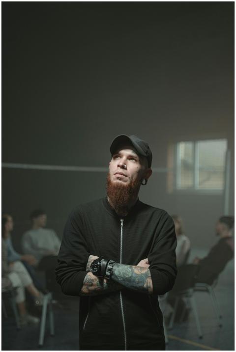 Thoughtful man in a group setting, surrounded by p