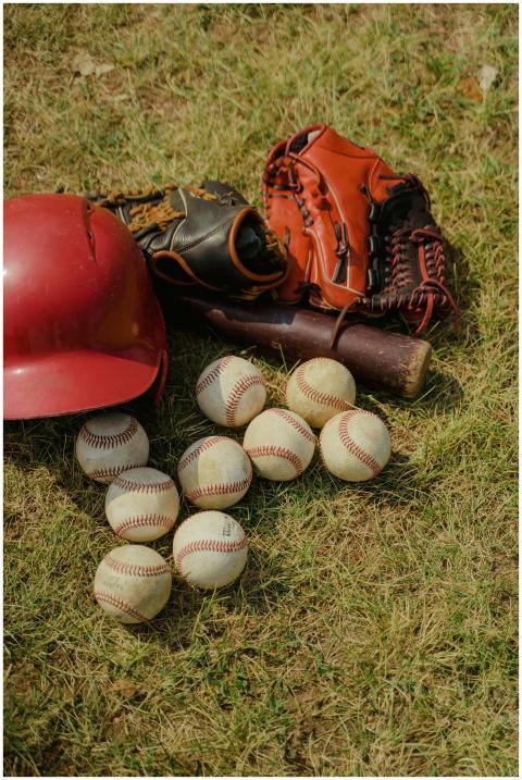 Baseball gear including balls, gloves, bat, and he