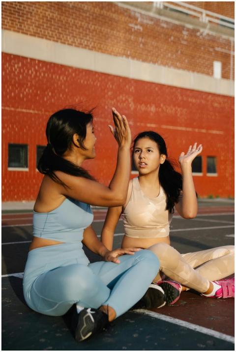 A mother and daughter share a high five during out