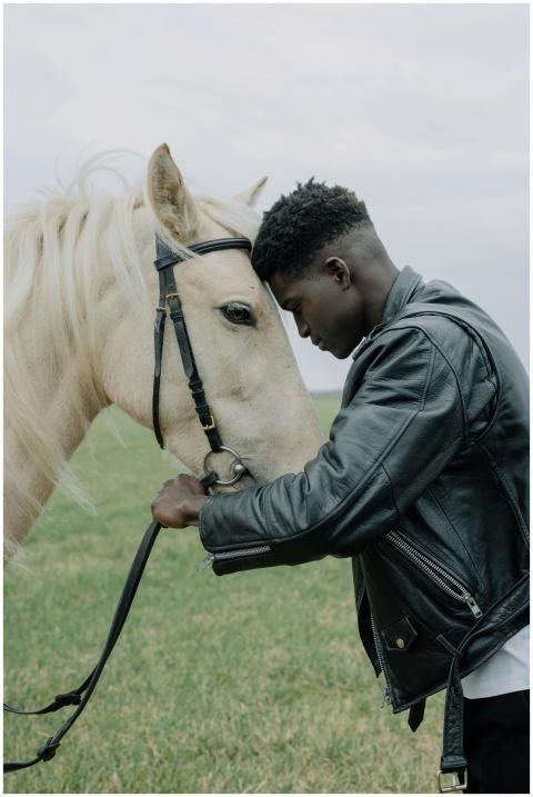 A touching moment between a black man in a leather