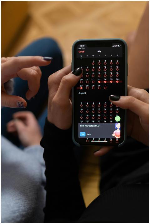 Close-up of hands interacting with a smartphone di
