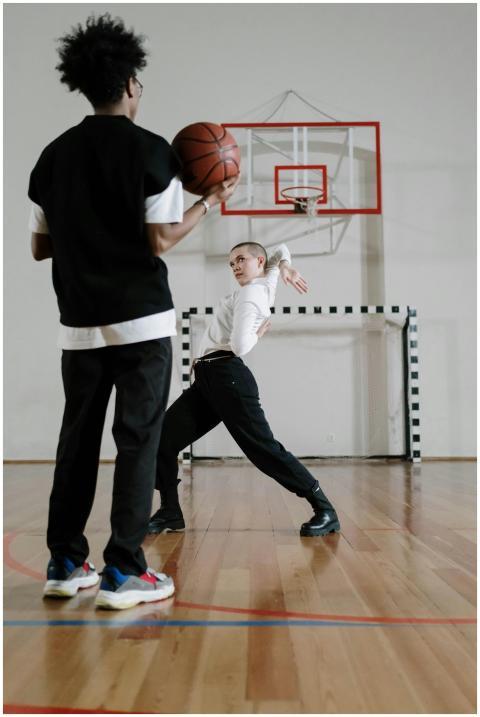 Teenage boys engaged in a dynamic basketball game
