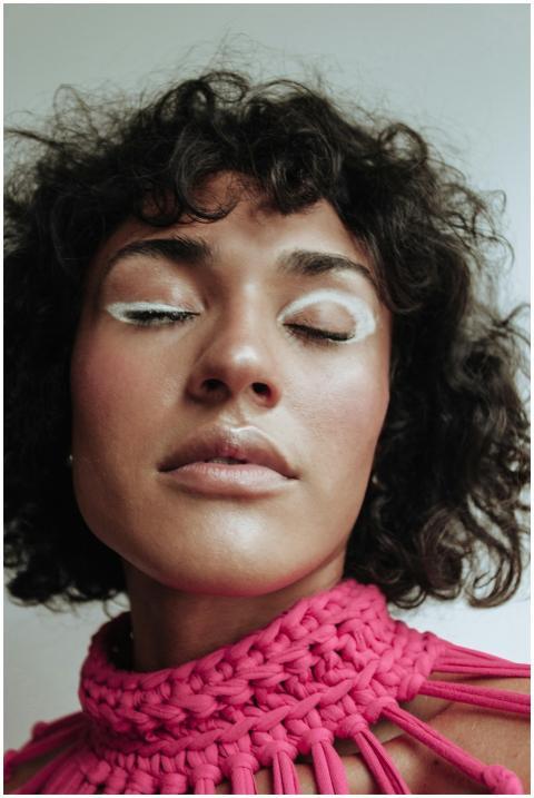 A close-up portrait of a woman with eye-catching c