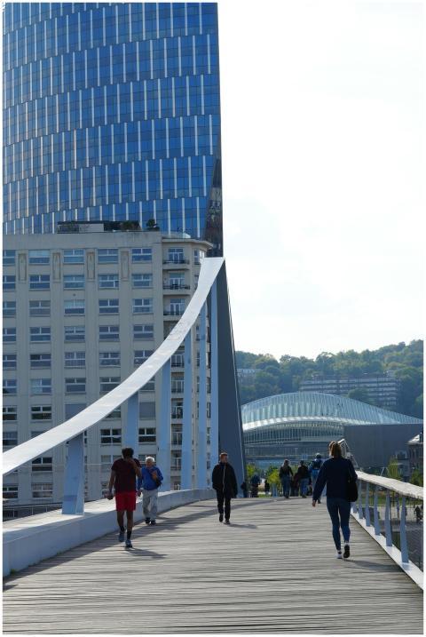 People walking on a bridge in Liège, Belgium, with