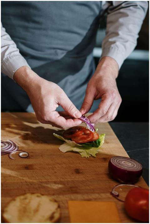 Chef assembling a vegetable sandwich with fresh in