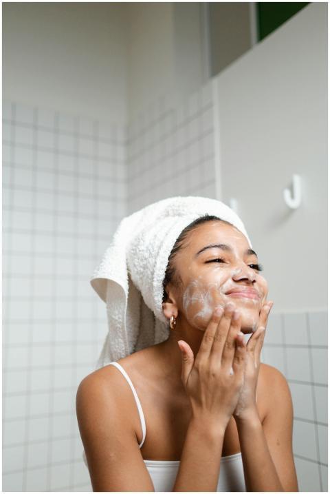 A young woman enjoying her skincare routine with a