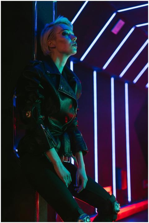Stylish woman posing in a futuristic nightclub ill