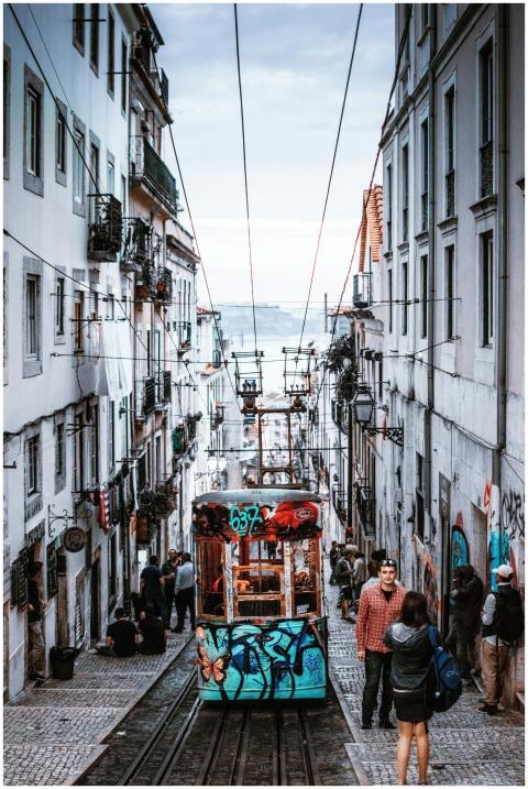 Vibrant city scene with a tram on steep narrow str