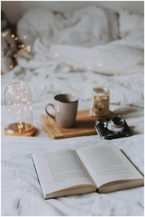 Cozy bedroom with coffee, book, and ambient string