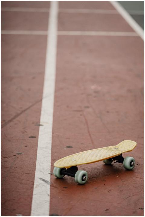 Modern yellow penny board with wheels placed on co