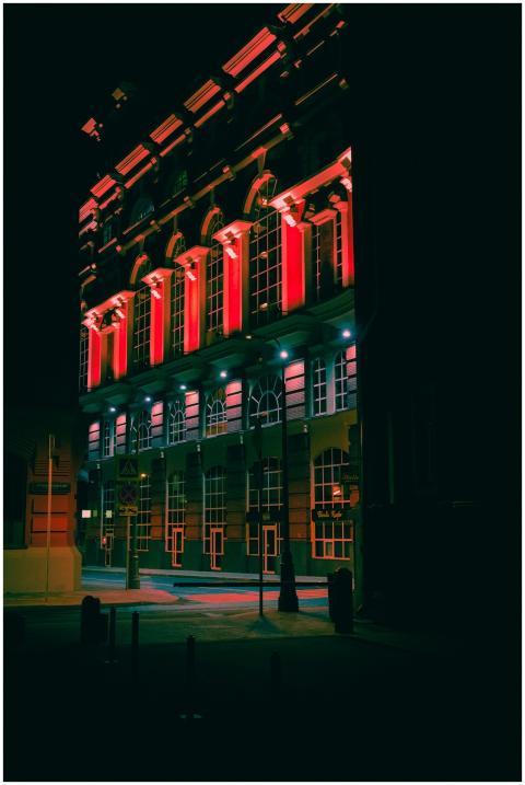 Dramatic view of an illuminated building with red
