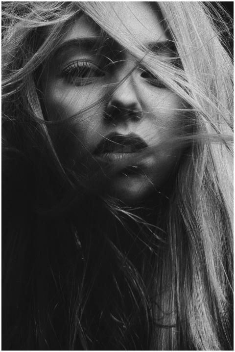 A dramatic black and white portrait capturing a wo