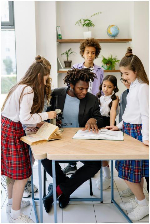 A teacher engages with students in a diverse class