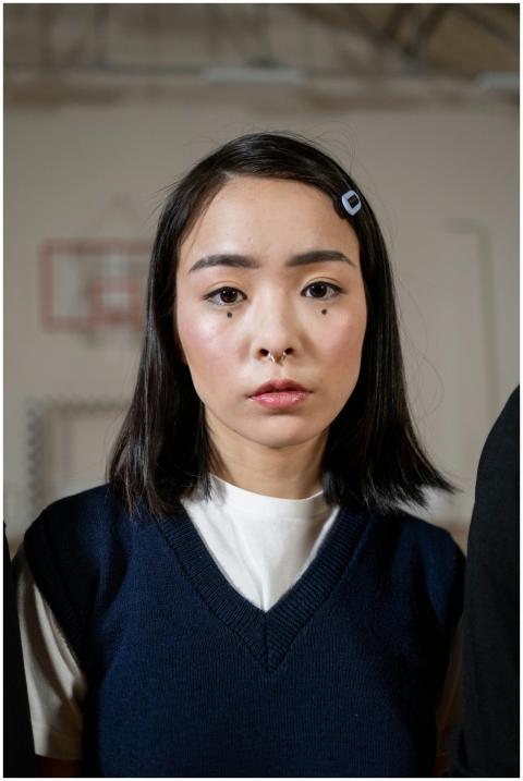 Close-up of a young woman with a bob haircut stand
