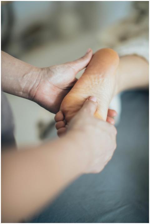 Close-up of hands giving a relaxing foot massage i