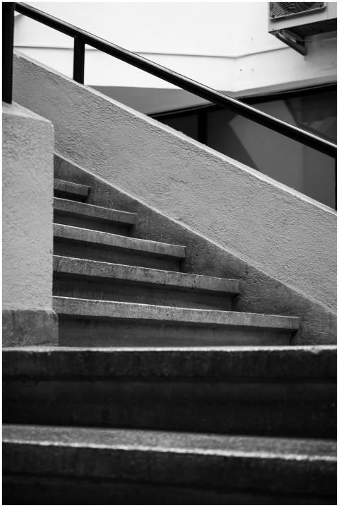 A black and white photo of a modern urban staircas