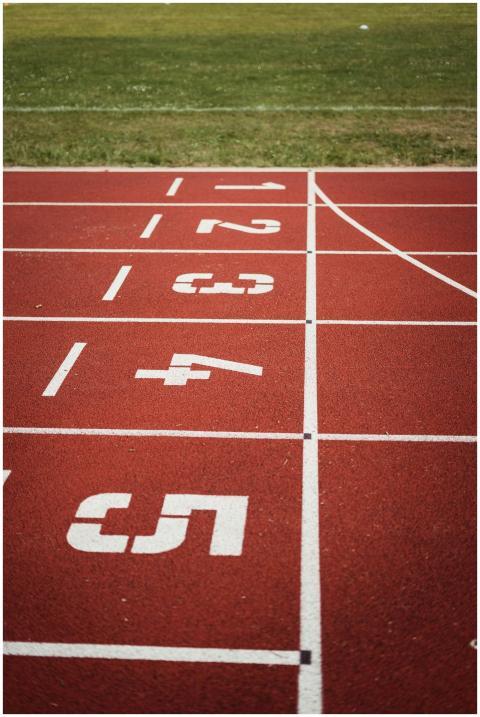Close-up view of a red running track with numbered
