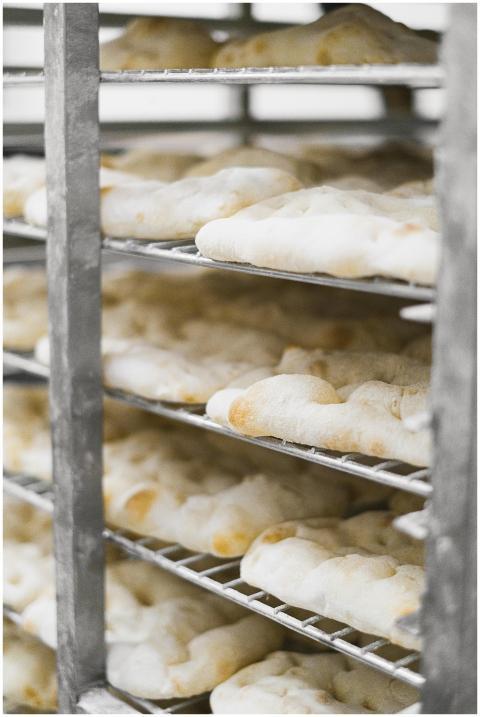 Close-up of freshly baked bread cooling on racks i