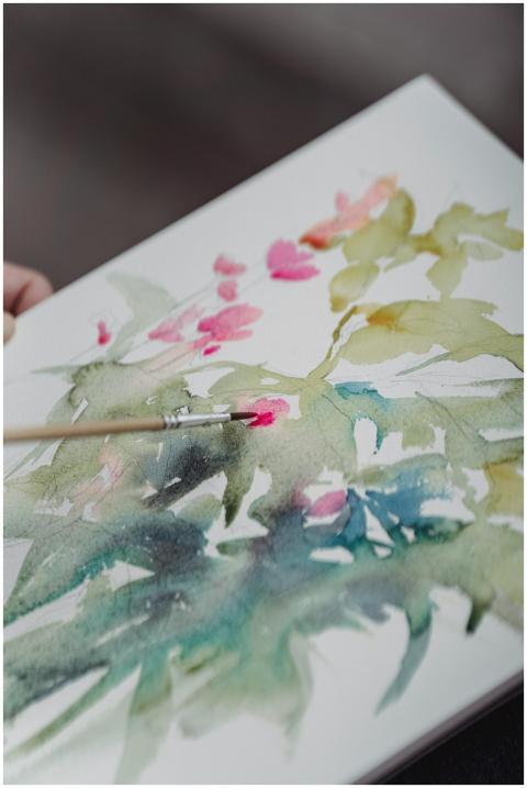 Vibrant watercolor painting in progress on a sketc