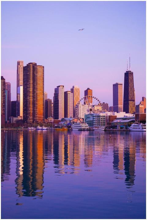 Chicago city skyline reflects on the river under a