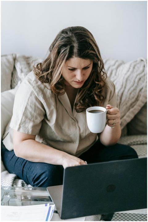 Woman concentrating on work at home, using her lap