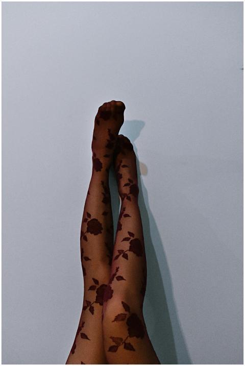 Close-up of floral print stockings against a minim