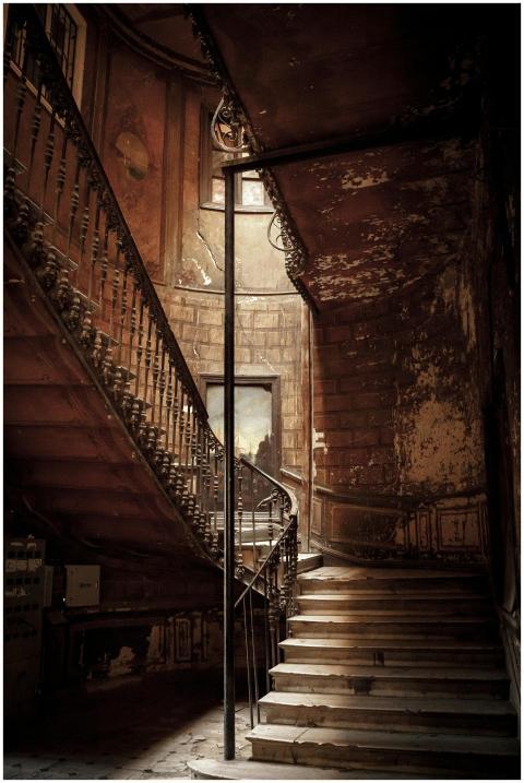 An eerie, vintage staircase in an abandoned buildi