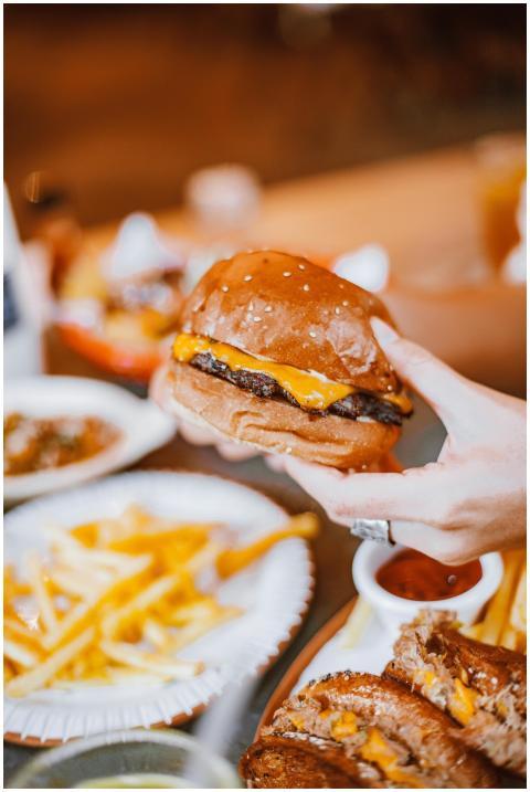 Close-up of a mouth-watering cheeseburger being he